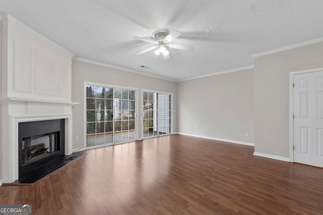 unfurnished living room with dark wood-style flooring, a fireplace with raised hearth, ceiling fan, a textured ceiling, and baseboards