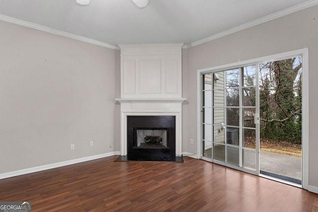 unfurnished living room with a large fireplace, baseboards, ornamental molding, and wood finished floors