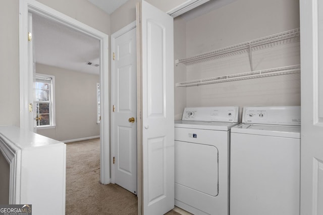 laundry room with laundry area, baseboards, visible vents, light colored carpet, and washing machine and clothes dryer