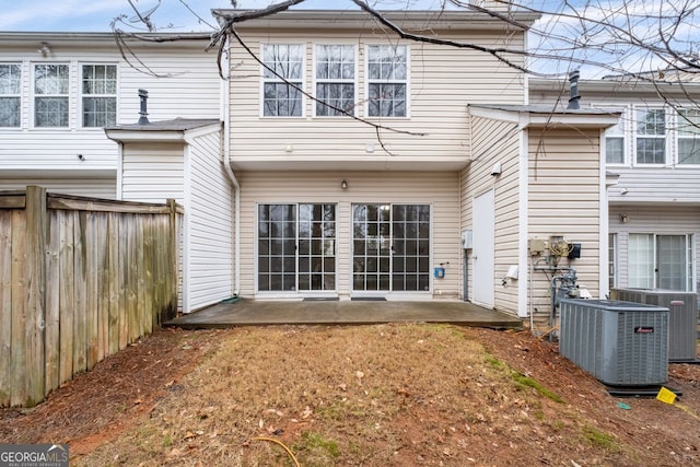 back of house with a patio area, fence, and central AC