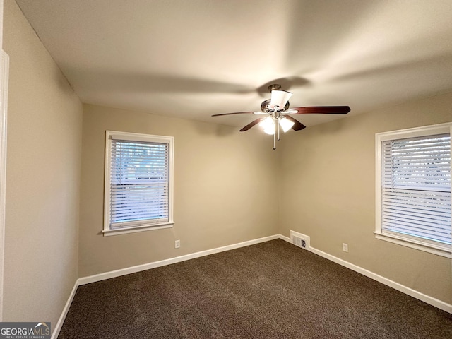 carpeted spare room with ceiling fan and a wealth of natural light