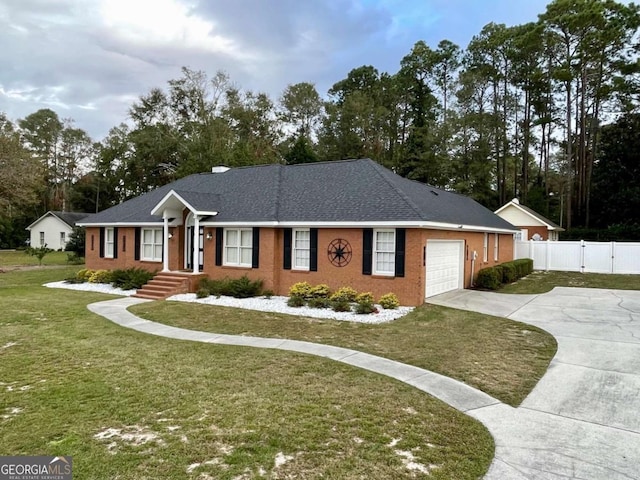 ranch-style house with a garage and a front lawn