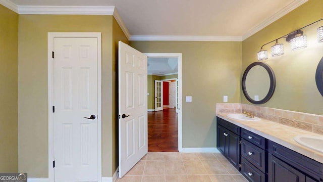 bathroom with vanity, ornamental molding, and tile patterned flooring