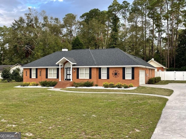 ranch-style home featuring a garage and a front yard