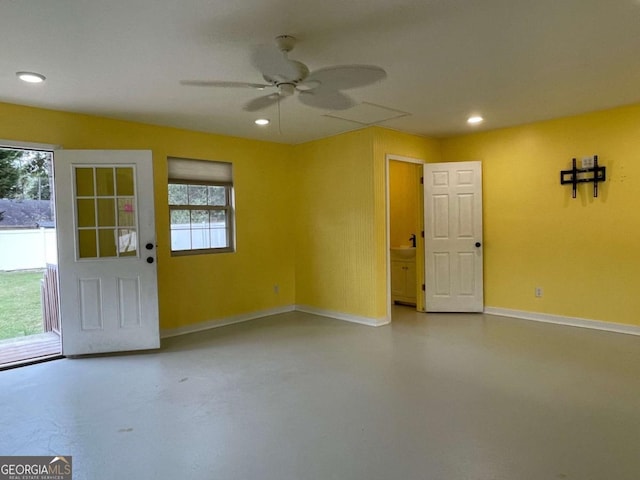 unfurnished room featuring ceiling fan and concrete flooring