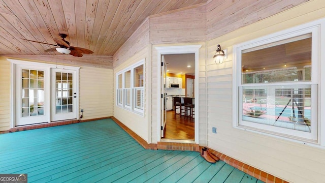 wooden terrace with ceiling fan and french doors