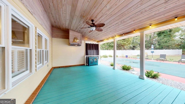 exterior space featuring ceiling fan and a fenced in pool