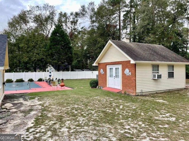 view of yard with an outbuilding, a patio, cooling unit, and a fenced in pool