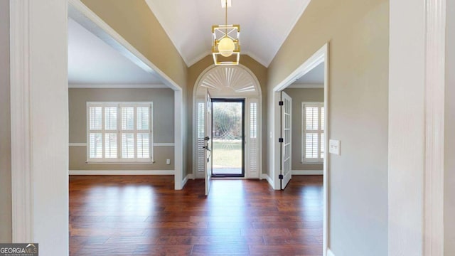 entrance foyer featuring crown molding, dark hardwood / wood-style floors, and vaulted ceiling