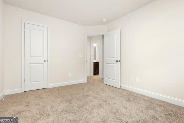 unfurnished room featuring light colored carpet