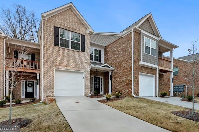 view of property featuring a balcony, a garage, and a front lawn