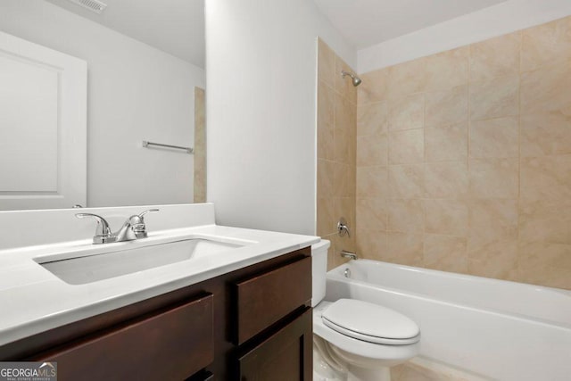 full bathroom with vanity, toilet, and tiled shower / bath combo