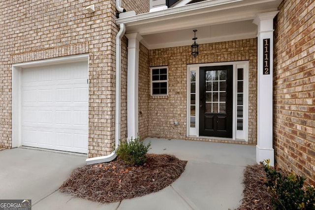 view of exterior entry with a garage