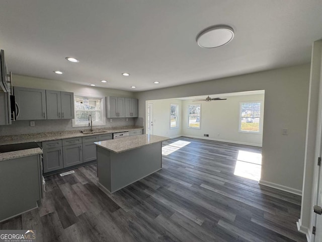 kitchen featuring a center island, a healthy amount of sunlight, and gray cabinetry