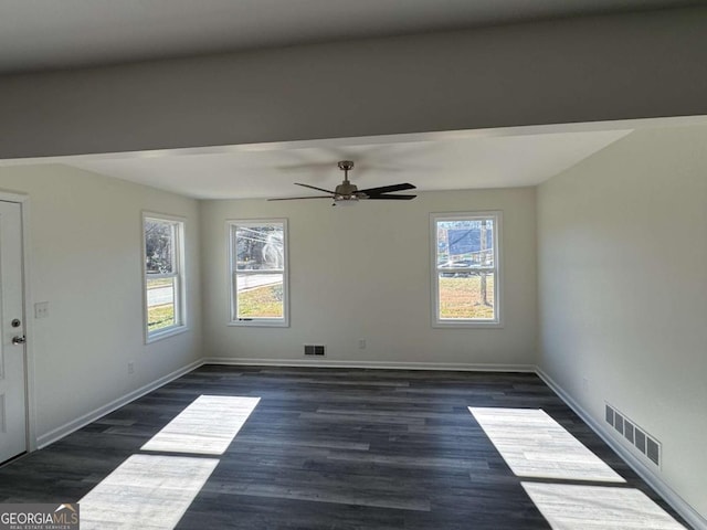 unfurnished room featuring ceiling fan and dark wood-type flooring