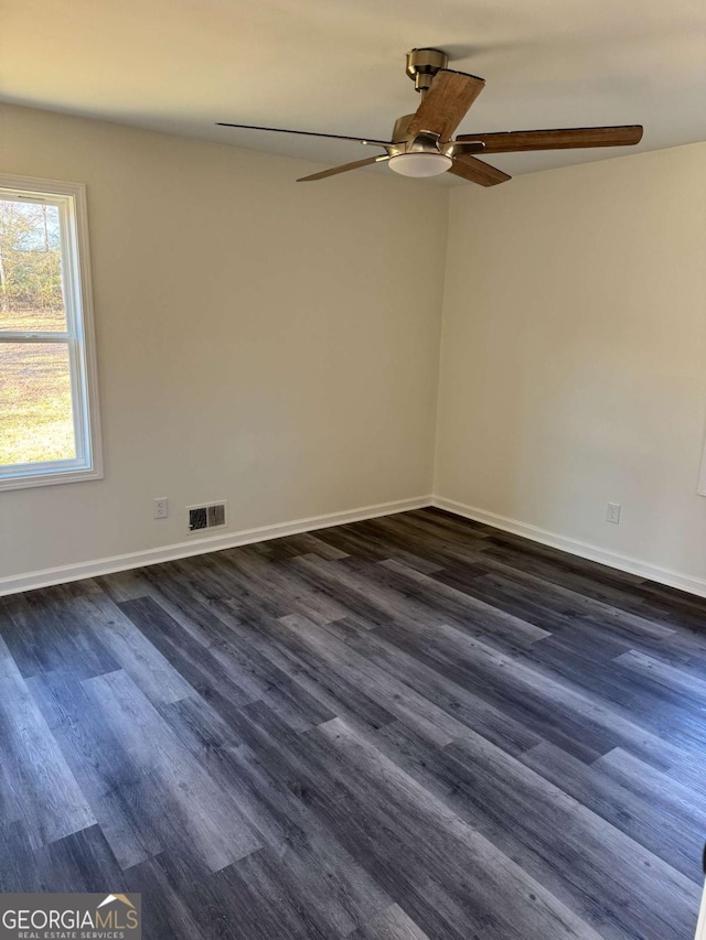 spare room featuring ceiling fan and dark hardwood / wood-style floors