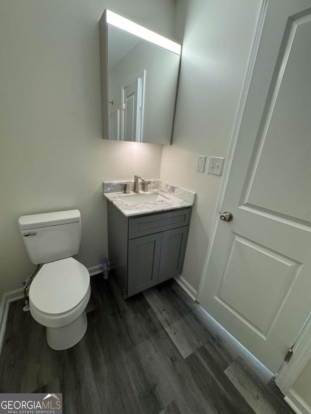 bathroom featuring hardwood / wood-style floors, toilet, and vanity