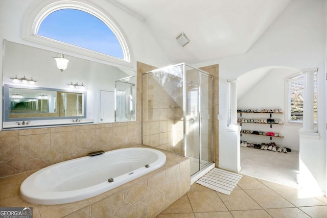 bathroom featuring plus walk in shower, decorative columns, vaulted ceiling, and tile patterned floors