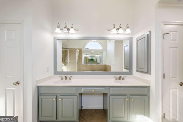 bathroom featuring vanity, a shower with shower door, and tile patterned floors