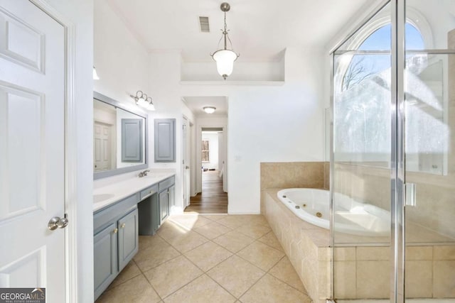 bathroom featuring shower with separate bathtub, vanity, and tile patterned flooring