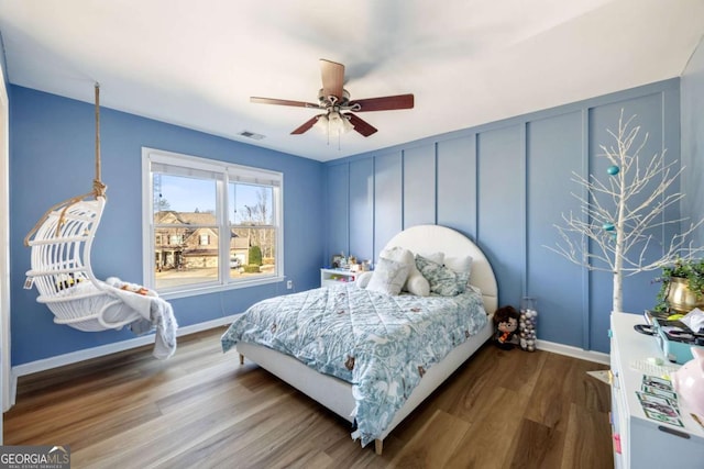 bedroom with ceiling fan and wood-type flooring