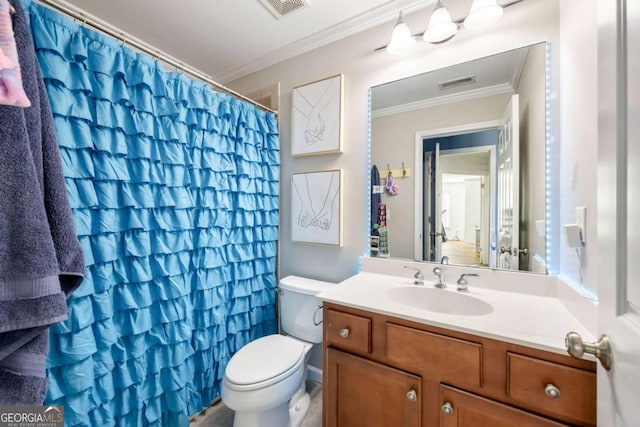 bathroom featuring vanity, toilet, and ornamental molding