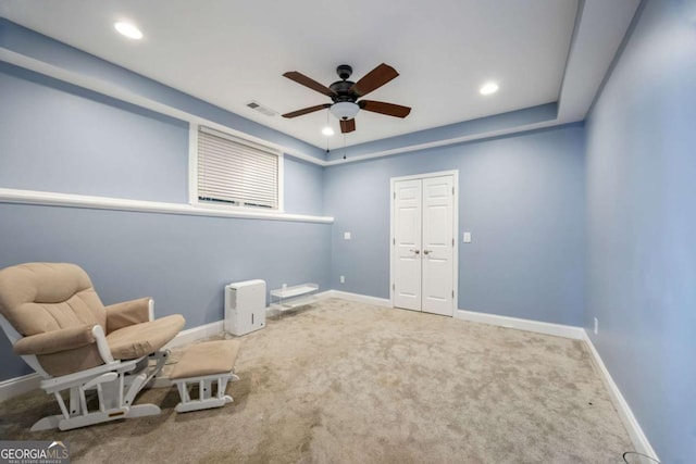 sitting room with carpet floors and ceiling fan