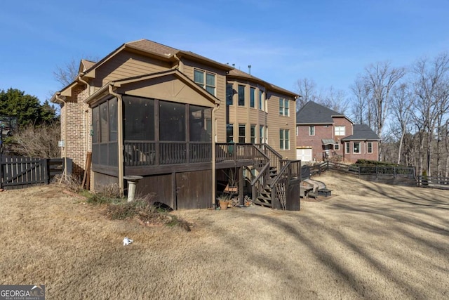 rear view of property with a sunroom