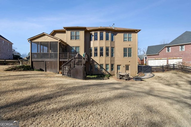 back of property with a sunroom and a yard