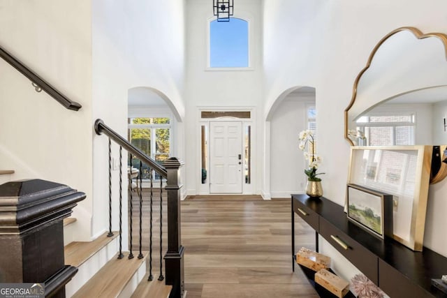 entrance foyer with a high ceiling and hardwood / wood-style floors