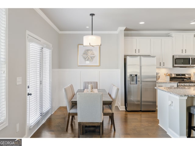 dining room featuring dark wood-type flooring and ornamental molding