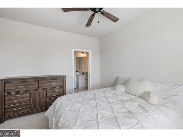 carpeted bedroom with ceiling fan and ensuite bath