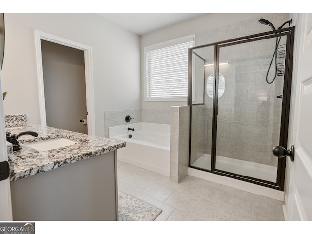 bathroom featuring plus walk in shower, tile patterned floors, and vanity