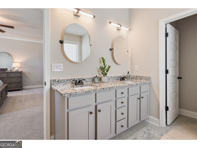 bathroom featuring ornamental molding, ceiling fan, and vanity