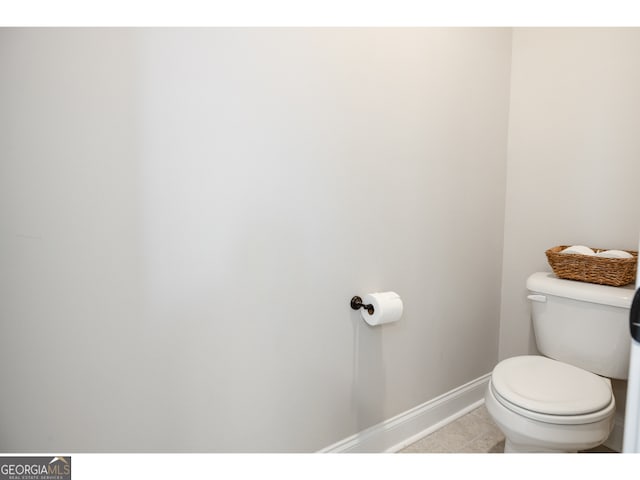 bathroom with toilet and tile patterned flooring