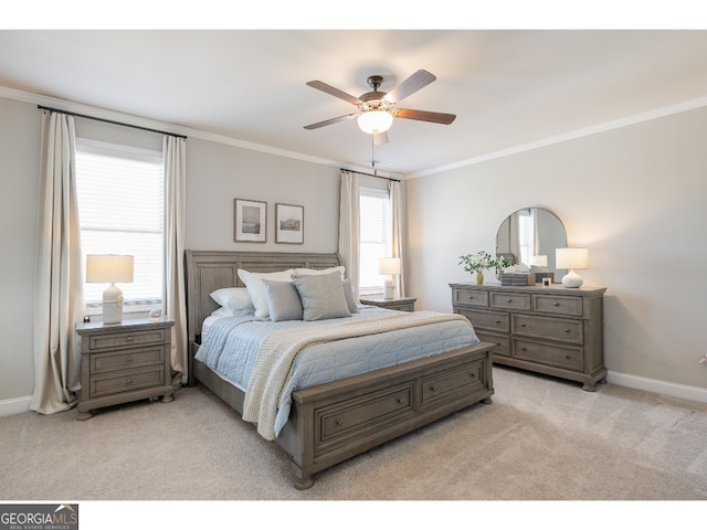 carpeted bedroom with ceiling fan and ornamental molding