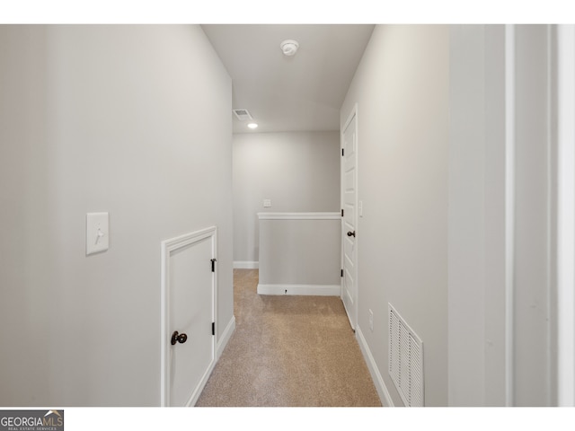 hallway with light colored carpet