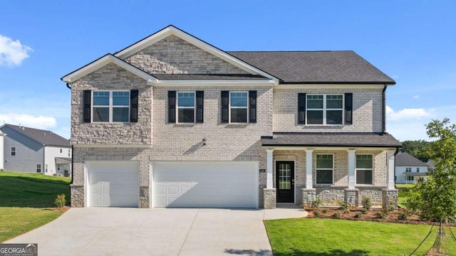 craftsman house featuring a garage, covered porch, and a front lawn