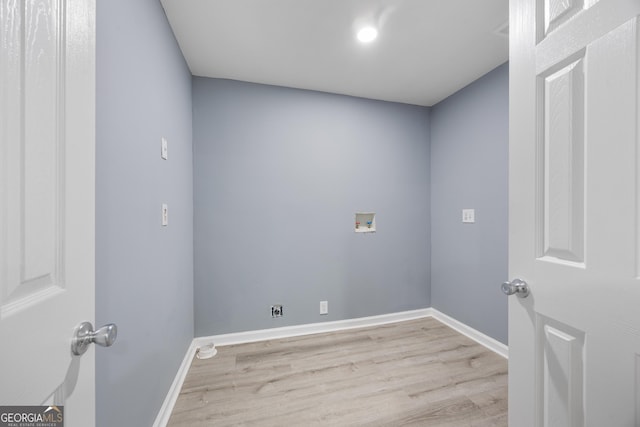 laundry room with washer hookup and light hardwood / wood-style flooring