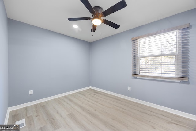 empty room with light hardwood / wood-style floors and ceiling fan