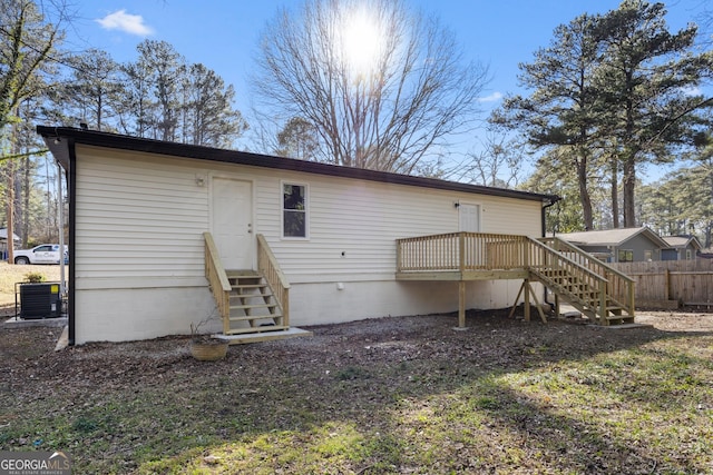 back of property featuring a wooden deck