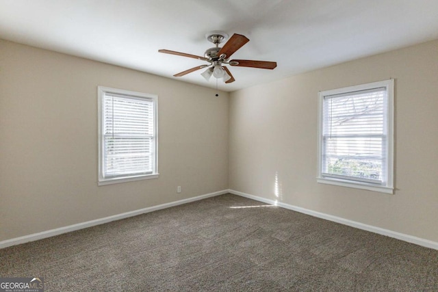 carpeted spare room with ceiling fan and a wealth of natural light