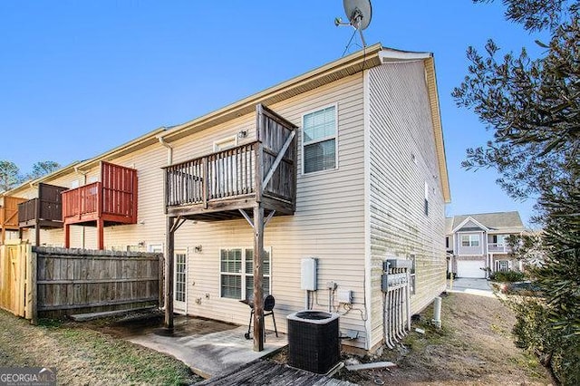 back of property featuring central AC, a balcony, and a patio area