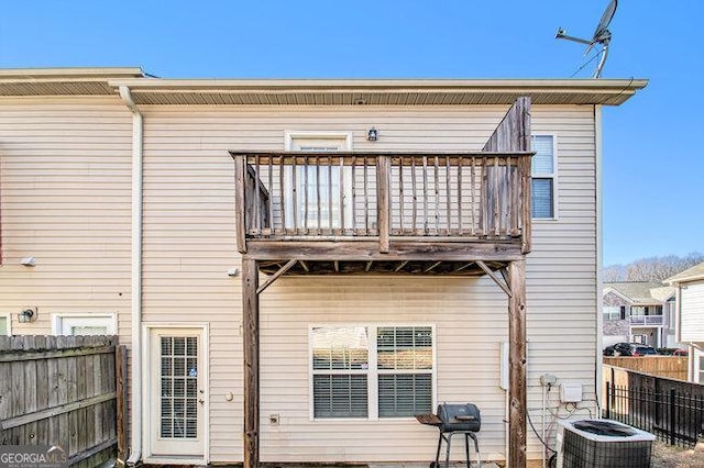 rear view of house with a balcony and central AC unit