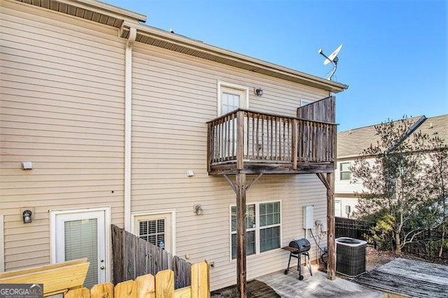 back of property featuring a balcony and central AC unit