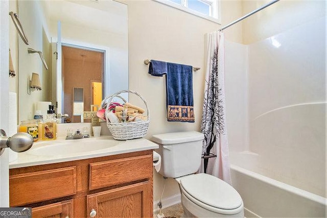 full bathroom with vanity, shower / tub combo, and toilet