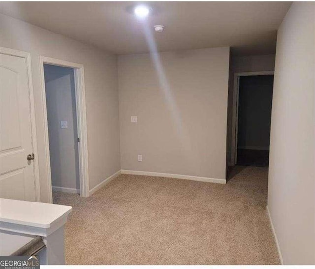 unfurnished room with light carpet