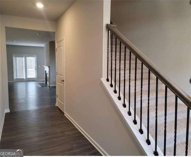 stairs featuring hardwood / wood-style floors