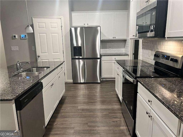 kitchen with sink, white cabinets, pendant lighting, and stainless steel appliances