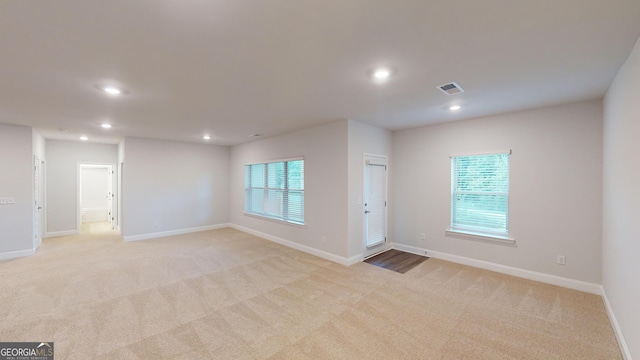 empty room featuring light colored carpet